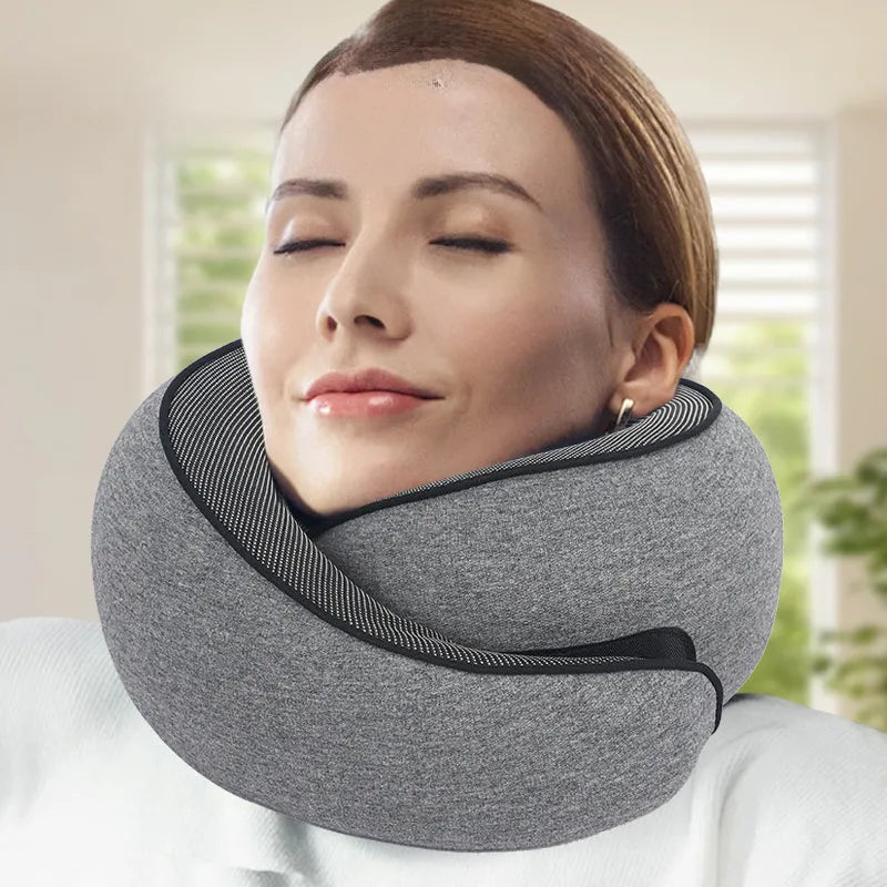 "JetComforts ergonomic travel neck pillow in grey, worn by a relaxed woman with eyes closed—perfect for neck support during flights or long trips."