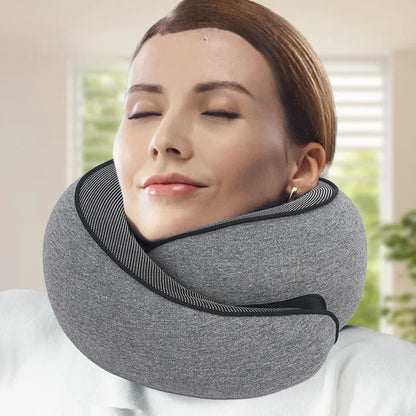 "JetComforts ergonomic travel neck pillow in grey, worn by a relaxed woman with eyes closed—perfect for neck support during flights or long trips."