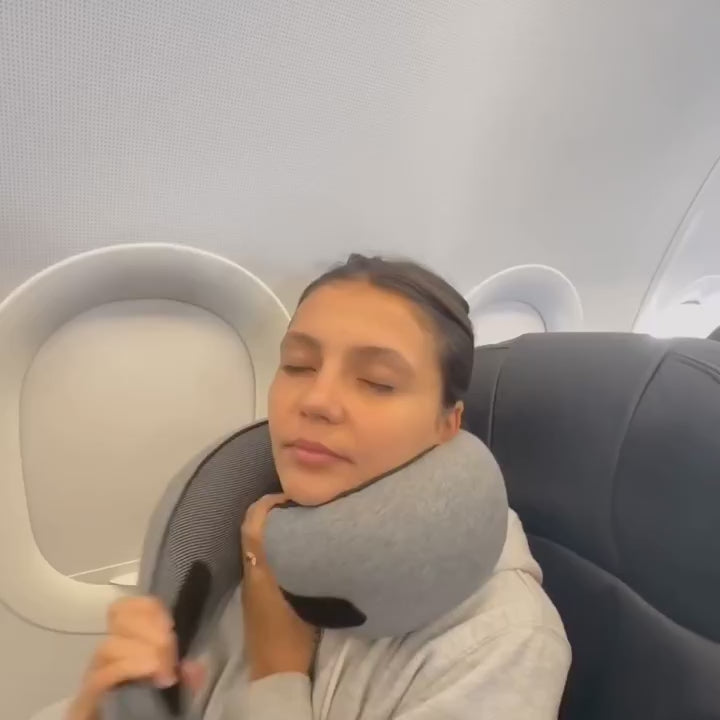 Video of woman comfortably using JetComforts memory foam travel neck pillow during airplane flight